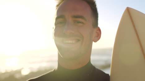 portrait of fit surfer holding surfboard