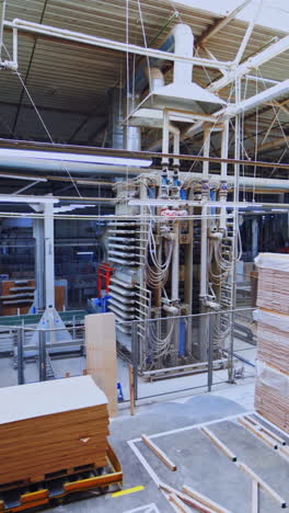 modernized factory interior. manufacture of furniture. high-tech automated machinery for production of wooden furniture. vertical video