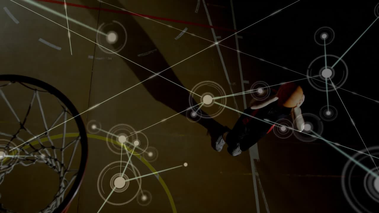 male athlete jumping at hoop in basketball court, showing sports tech network-style overlays
