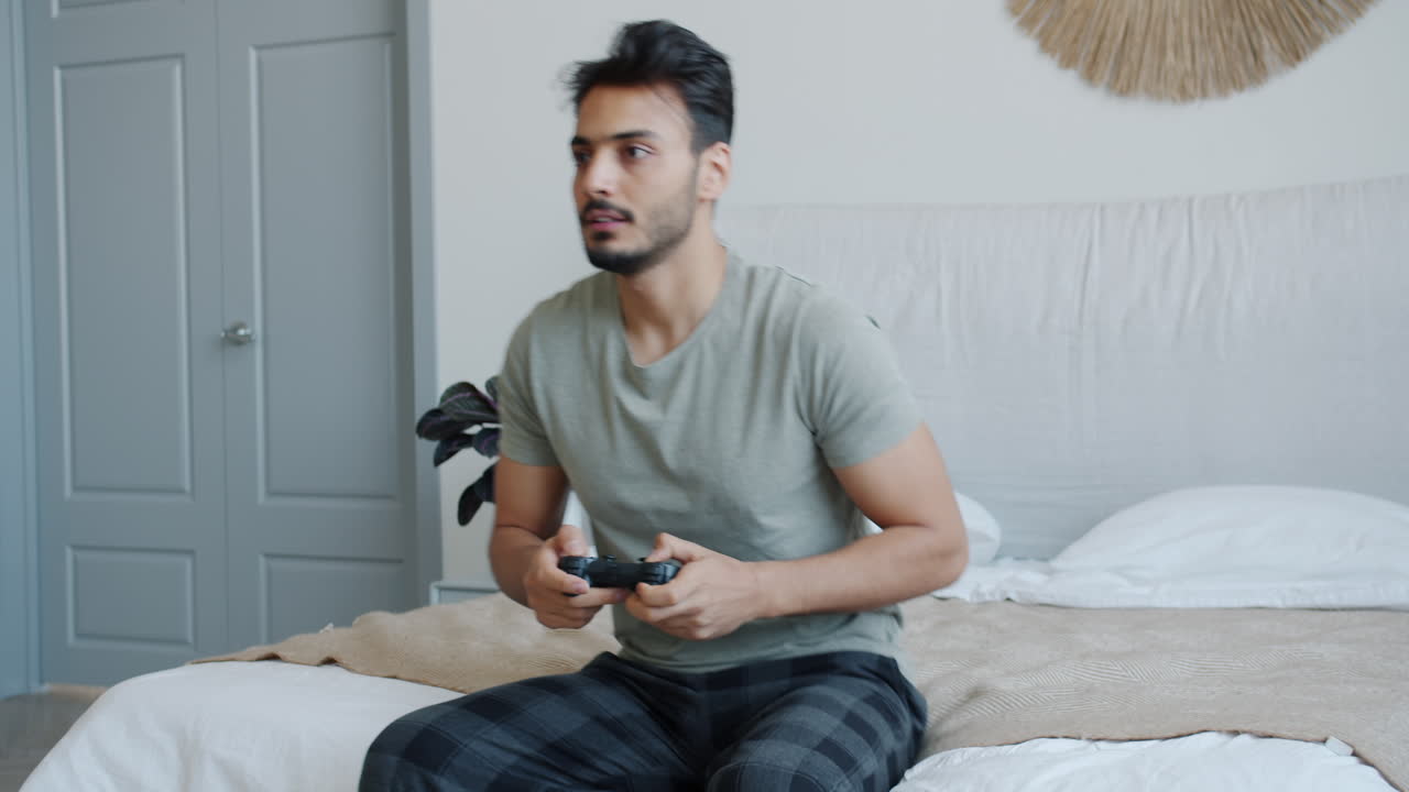 Man playing video games in his bedroom