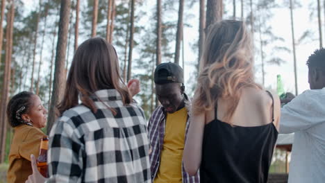young people celebrating in the forest