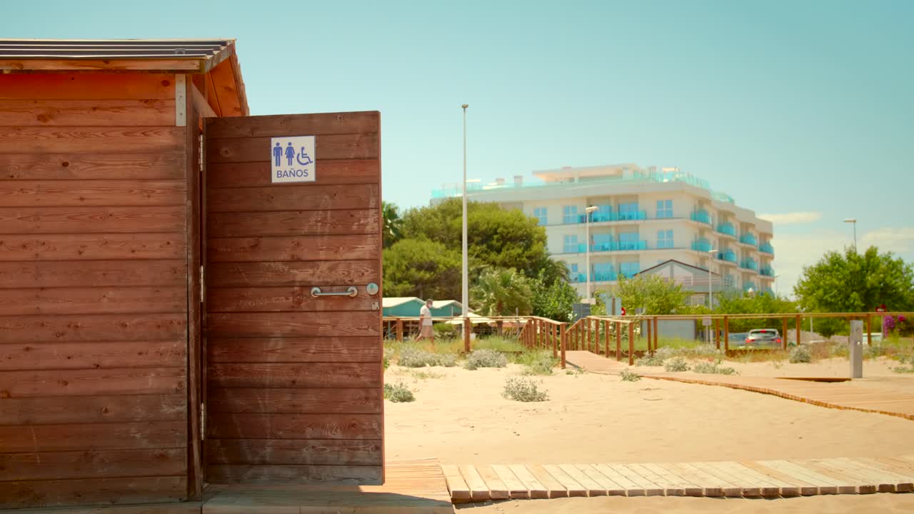 Wooden Beach Toilet With Door Open At Alcossebre In Spain. - wide shot