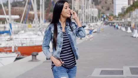 trendy relaxed young woman talking on a mobile