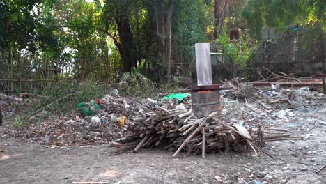 burning trash and wood in a barrel outdoors