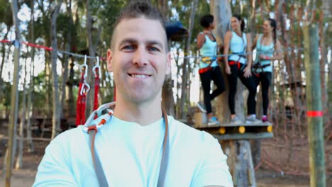 Man-looking-at-the-woman-on-zip-line-and-smiling-at-camera-4K-4k