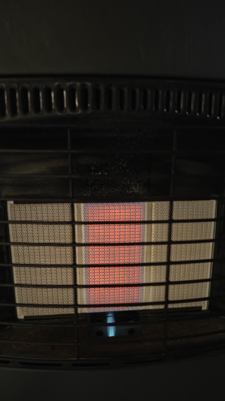 Close view of red heat glow and blue pilot flame disappearing from a portable LPG appliance. Suitable for safety, shutdown, or fuel interruption concepts