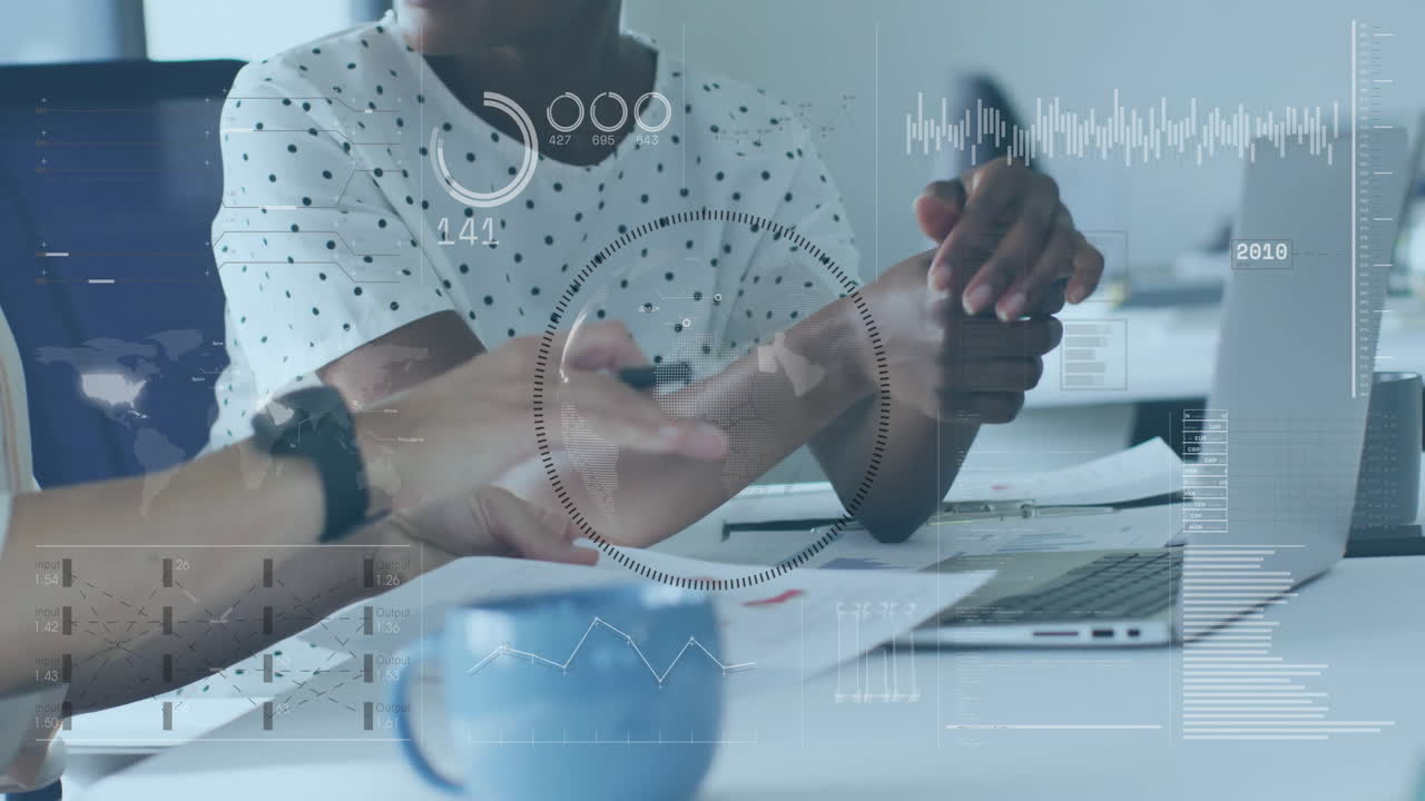 Discussing business strategy, colleagues with data analytics animation over office setting