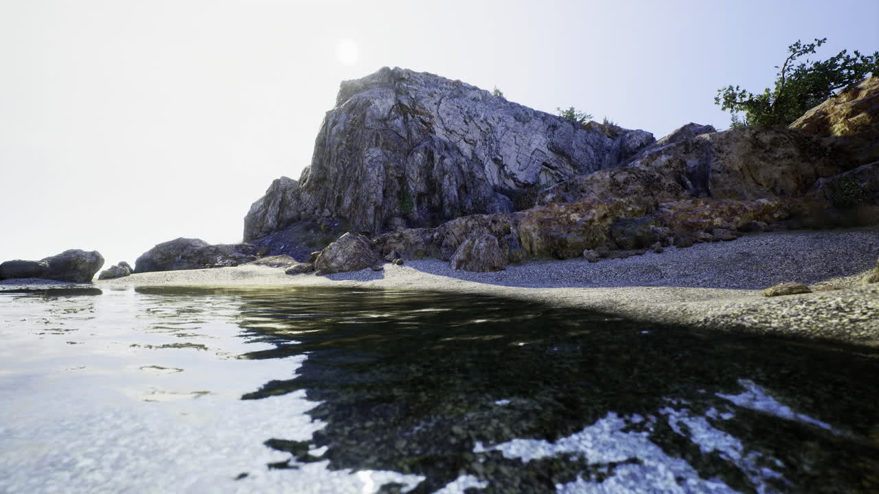 Rocky coastline with clear water and sunny sky on a tranquil day