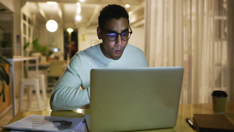 latin businessman eating dinner while working