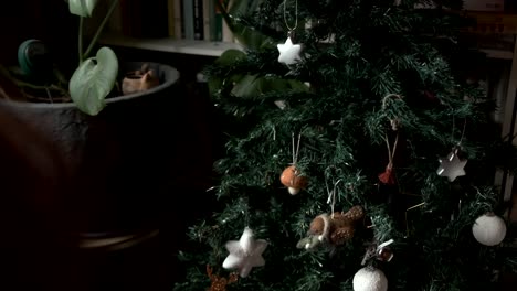 woman decorating a christmas tree with cute felt mushroom decoration 4k