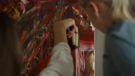 woman hand making brush stroke in studio. little artist creating masterpiece.