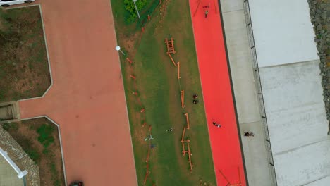 aerial view of urban park with playgrounds and running track