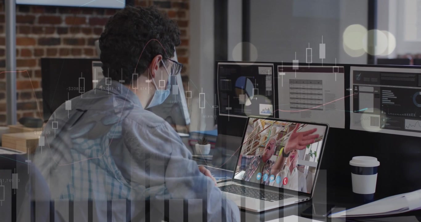 Data processing over caucasian man wearing a face mask having a video call on laptop at office
