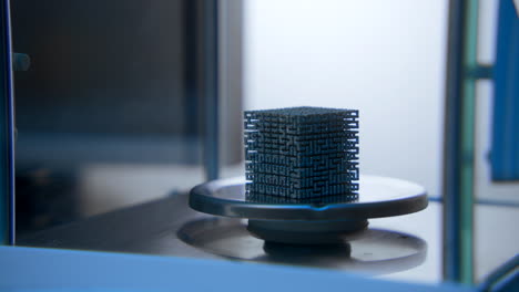 3d printed metal cube on a build plate
