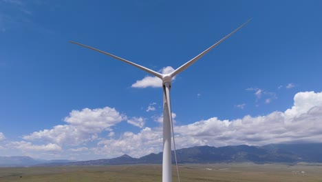 Static-wind-turbine-in-front-of-picturesque-mountainous-backdrop