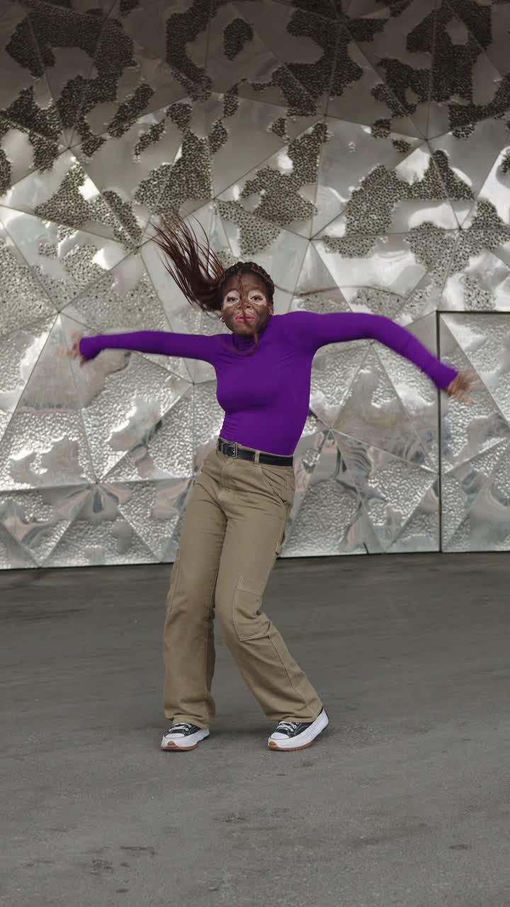 Woman dancing in urban setting