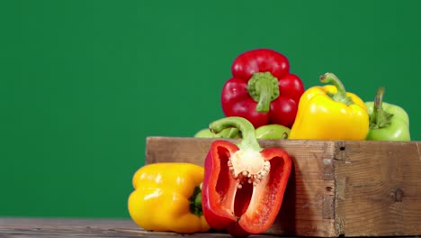 sweet peppers various colors in wooden box slowly rotate.