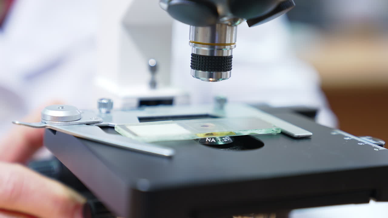 Close-up view of a microscope in use.