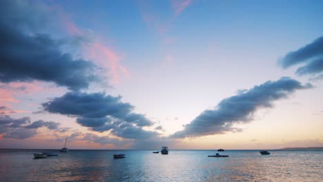 Landscape-of-multiples-fishing-boats-laying-in-the-harbor-during-the-sunset-in-Boka-Sami,-Curacao