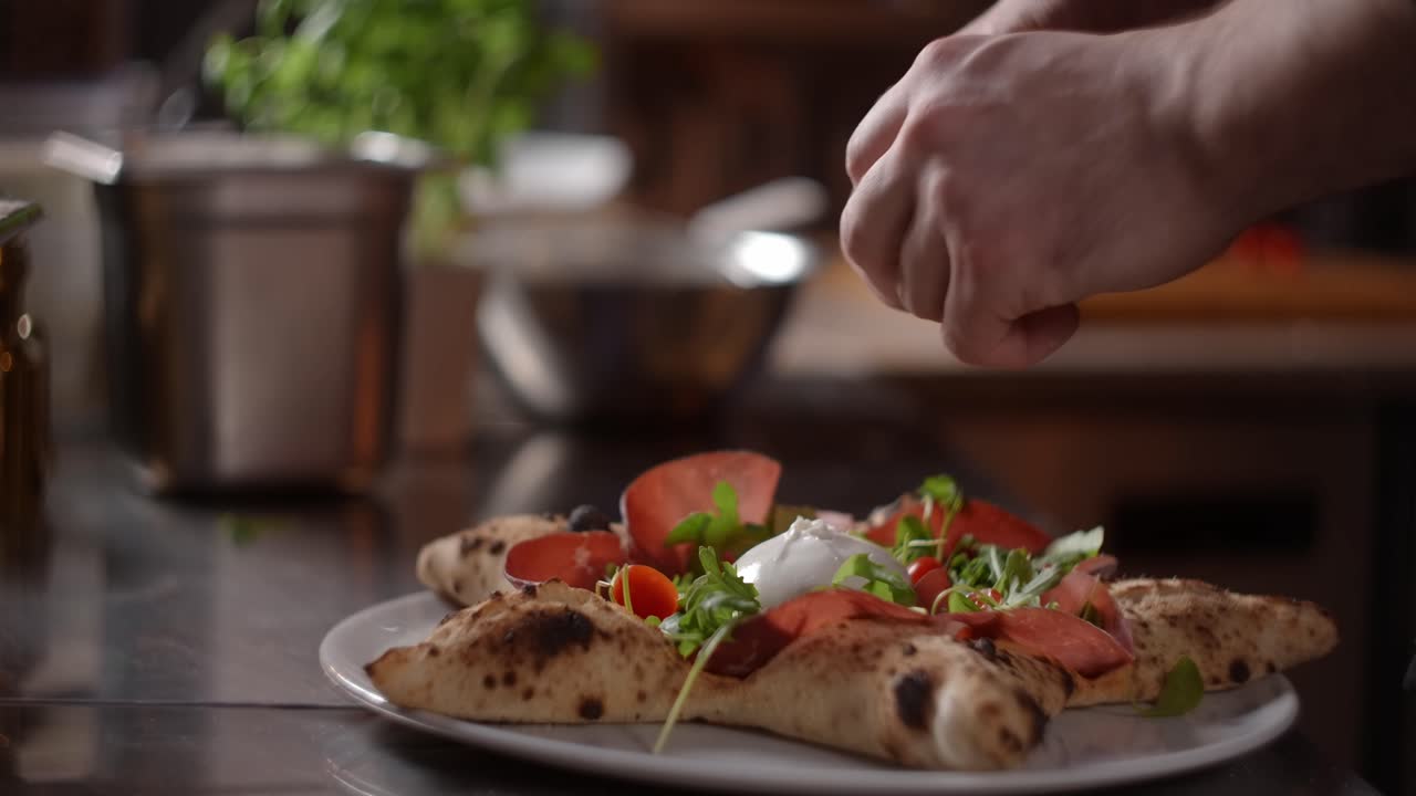 Chef Preparing a Star-Shaped Pizza with Burrata and Prosciutto