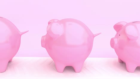 moving line of pink piggy banks into which one coin falls.