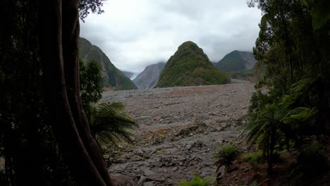 wide angle view looking towards the mouth of fox glacier which is shrouded in thick mist