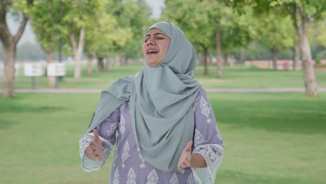 angry muslim woman shouting to the camera in park