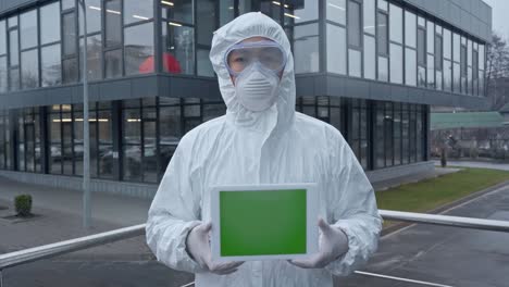 asian scientist holding digital tablet with green screen