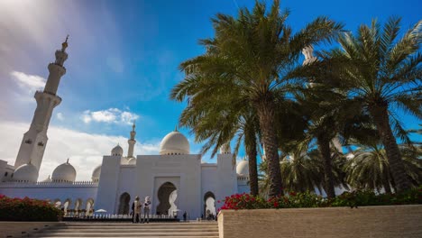 blue sunny sky abu dhabi grand mosque front palm tree entrance 4k time lapse uae