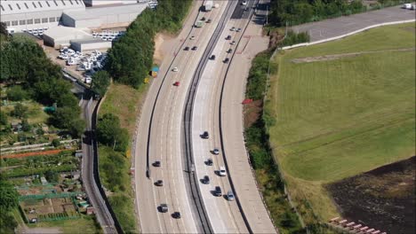 busy motorway aerial drone tracking shot showing cars and trucks on the m27