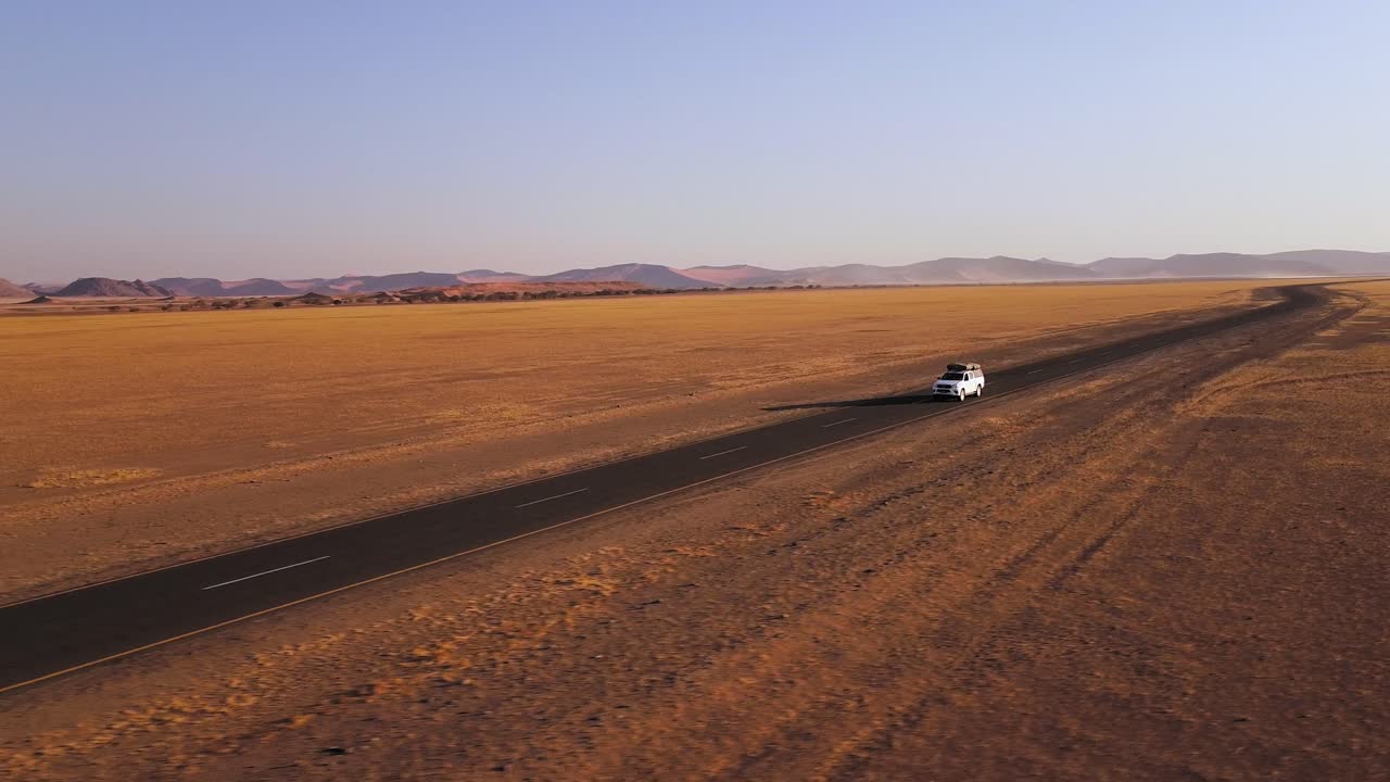 Namibian self-drive wildlife adventure with a rooftop-tent equipped Toyota Hilux in Sossusvlei's iconic sand dunes at sunset