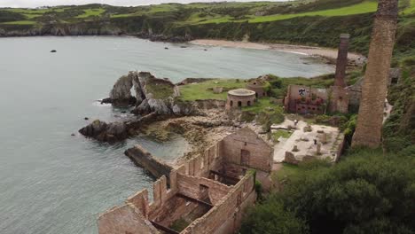 aerial view exploring deserted remains of porth wen industrial brickwork factory on eroded anglesey coastline