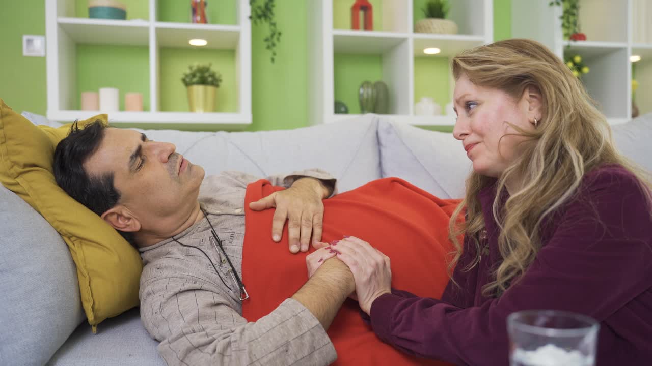 충성스러운 여성이 아픈 남편을 돌보고 있습니다. 아픈 성숙한 남자