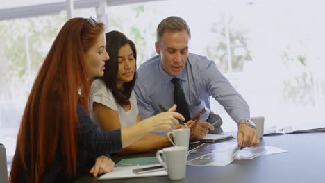 business colleagues discussing over documents 4k