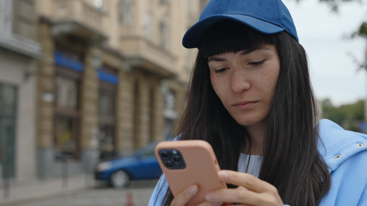 Woman Celebrating Success on Smartphone in City
