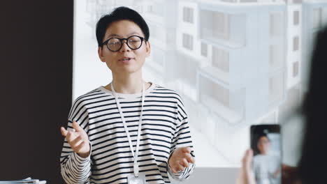 asian woman speaking to audience on architecture conference