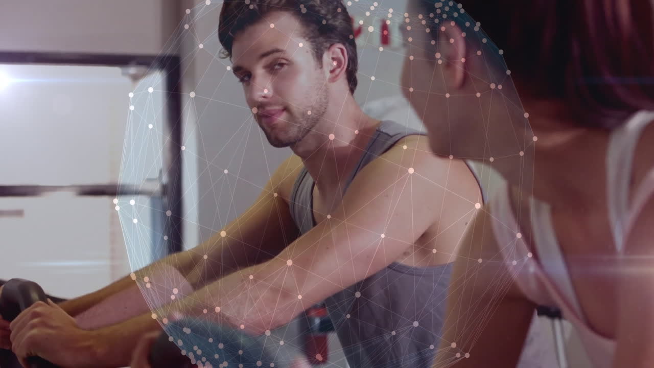 Man and woman exercising at gym with digital network overlay animation