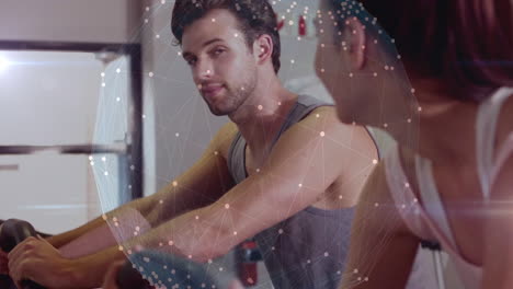 man and woman exercising at gym with digital network overlay animation