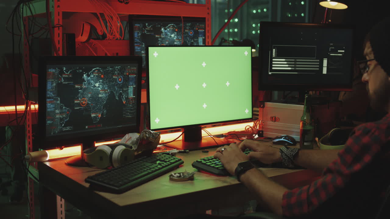 Hacker working on a computer in a server room