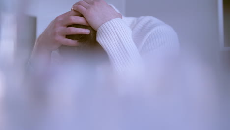 close-up of hands of a caucasian man holding his head in a desperate attitude