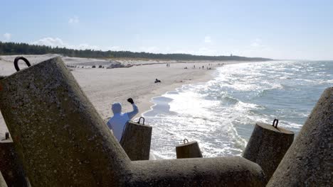 a breakwater on the beach, with sand visible behind its elements, perhaps even beachgoers