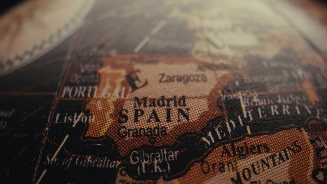 Close-up of a vintage world globe, focusing on the Spain region