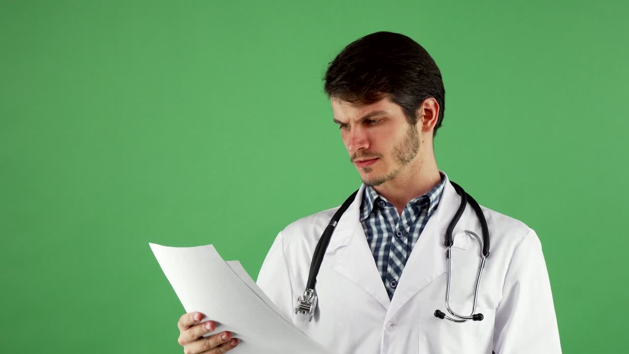 Attractive male practitioner checking medical documents