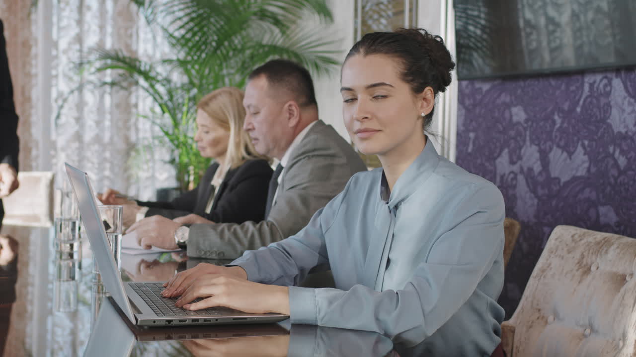 Young Business Woman Working On Laptop At Conference