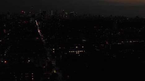 Long-twilight-drone-aerial-flyover-Harlem,-NYC