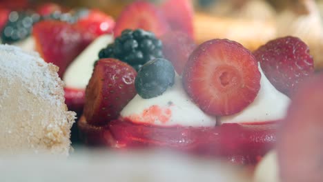 close-up of strawberry tartlets with whipped cream