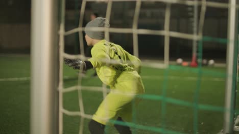 a children's football team trains at the stadium under the guidance of a coach. kids in sports uniforms practice ball exercises, improve technique, and develop teamwork on the green field