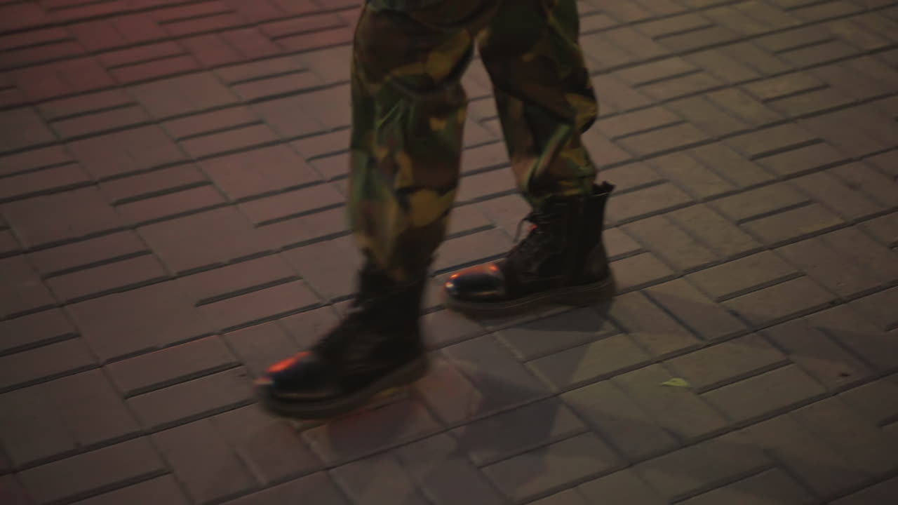 Soldier Boots Walking On Pavement At Dusk, CloseUp Of Camo Trousers And Combat Boots, Rhythmic Footsteps Casting Long Shadows On Brick Tiles, Solitary Patrol Vibe With Tactical Tension And Nocturnal