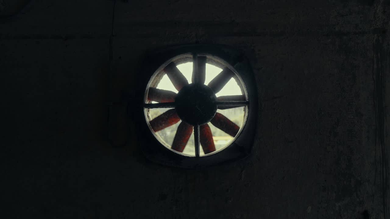 Old Industrial Ventilation Fan Rotating in a Dark Room