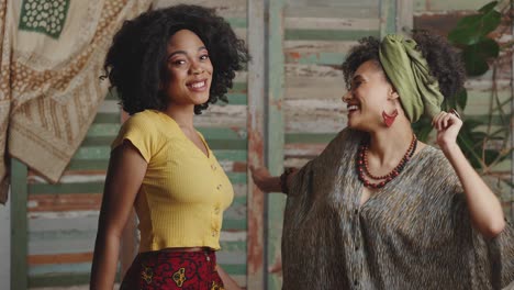 two stylish african american ladies dancing together, enjoying dynamic music at rustic interior, slow motion